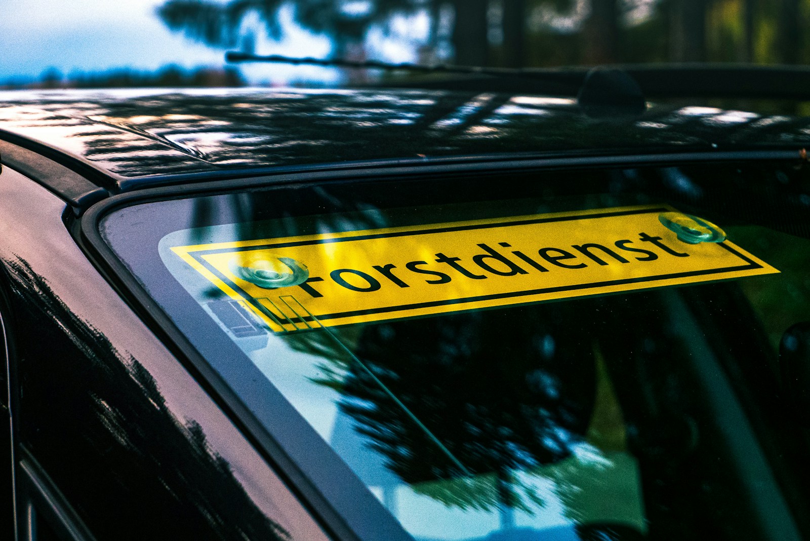 a black car with a yellow sticker on it